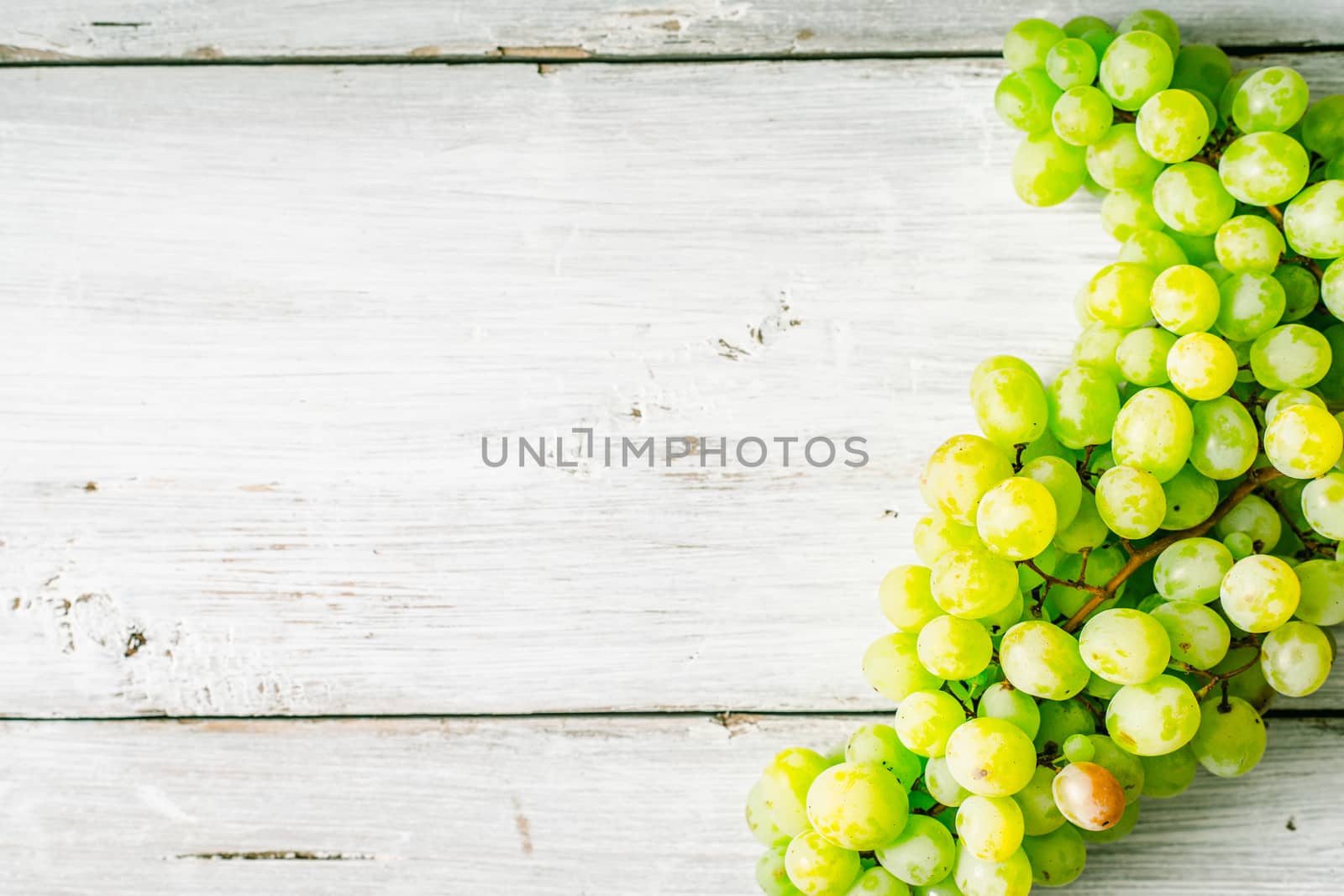 Grapes on the white wooden table horizontal by Deniskarpenkov