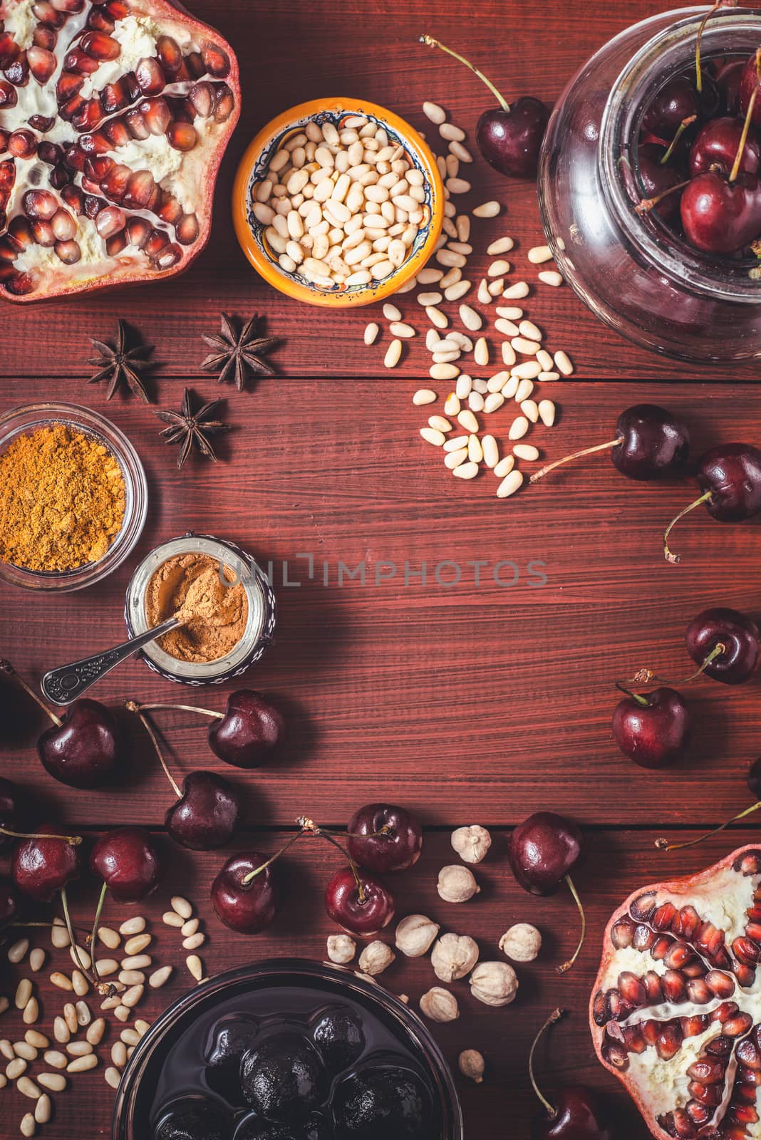 Different fruit and spices on the red wooden table. Concept of oriental fruits by Deniskarpenkov