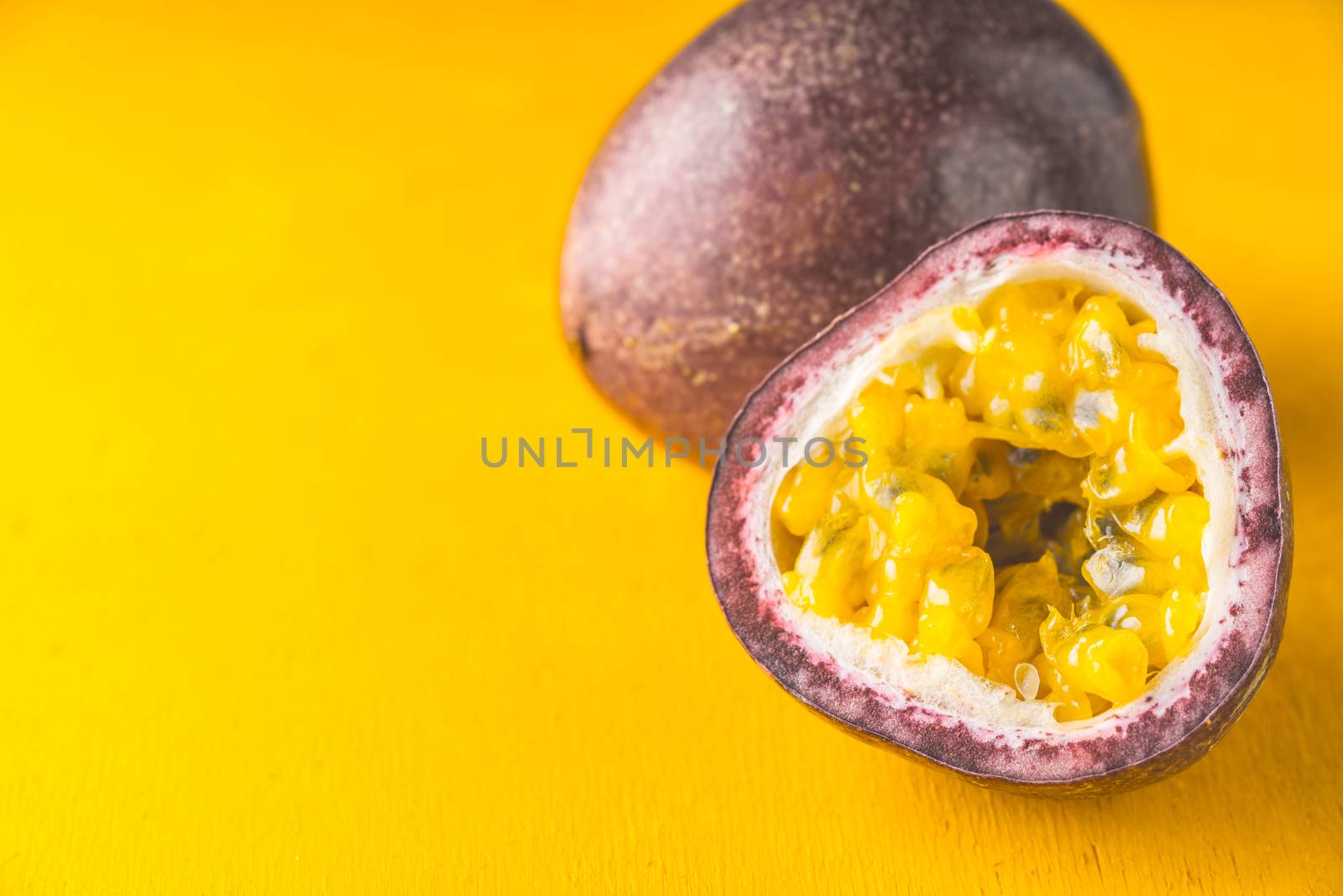 Passion fruit on the yellow background horizontal by Deniskarpenkov