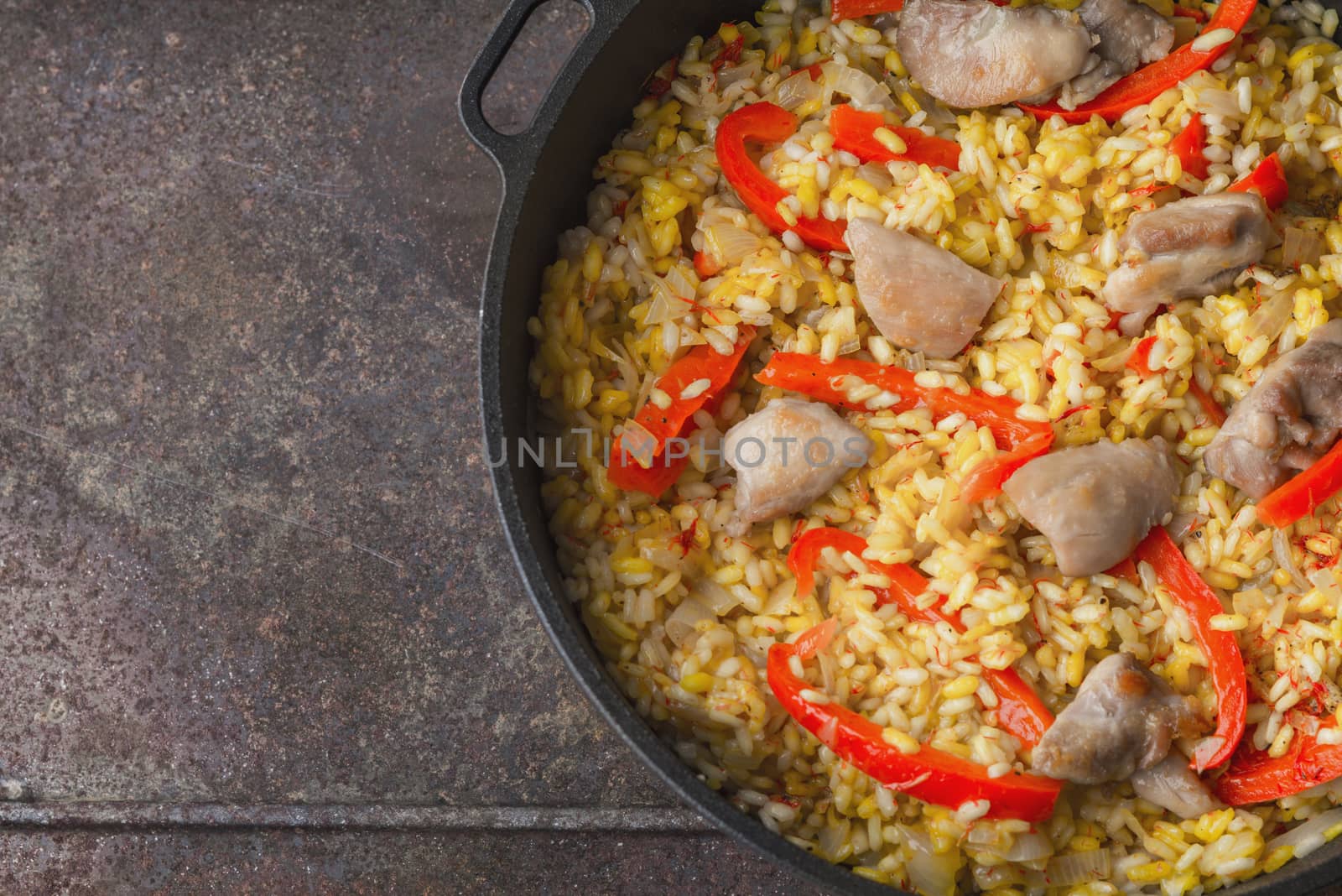 Rice with vegetable and chicken in the pan on the metal background top view by Deniskarpenkov