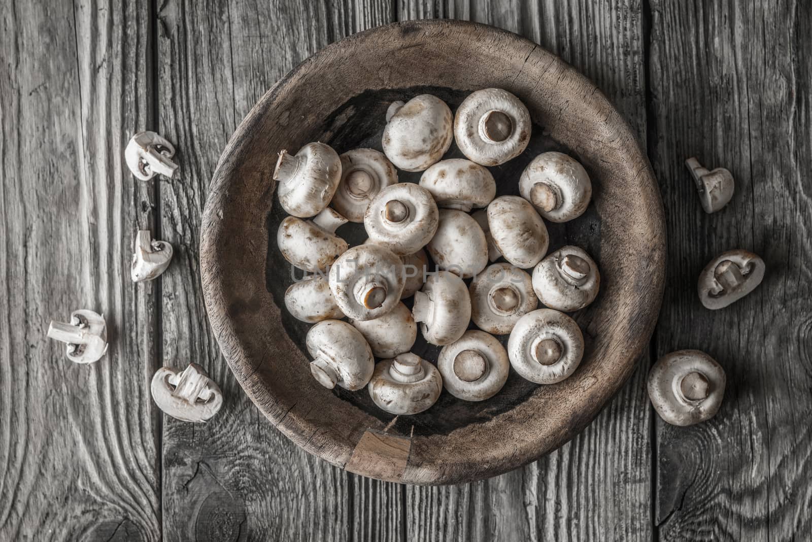 Champignon on the wooden bowl on the old table top view