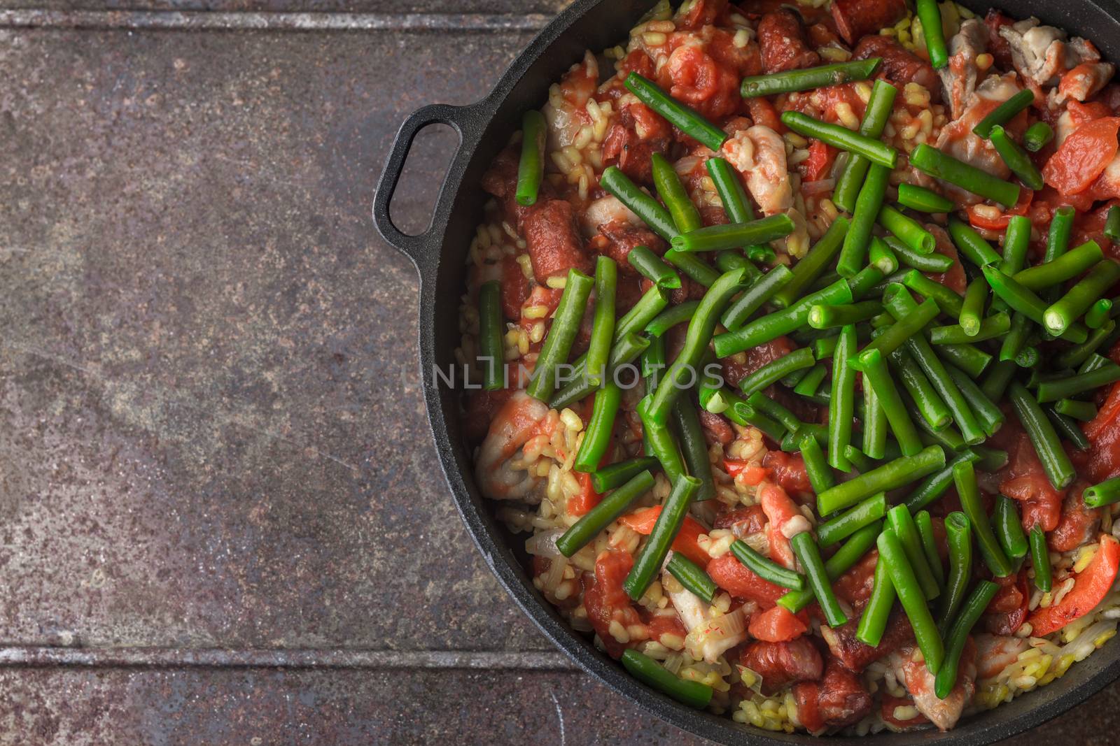 French bean on the pan with cooking paella top view