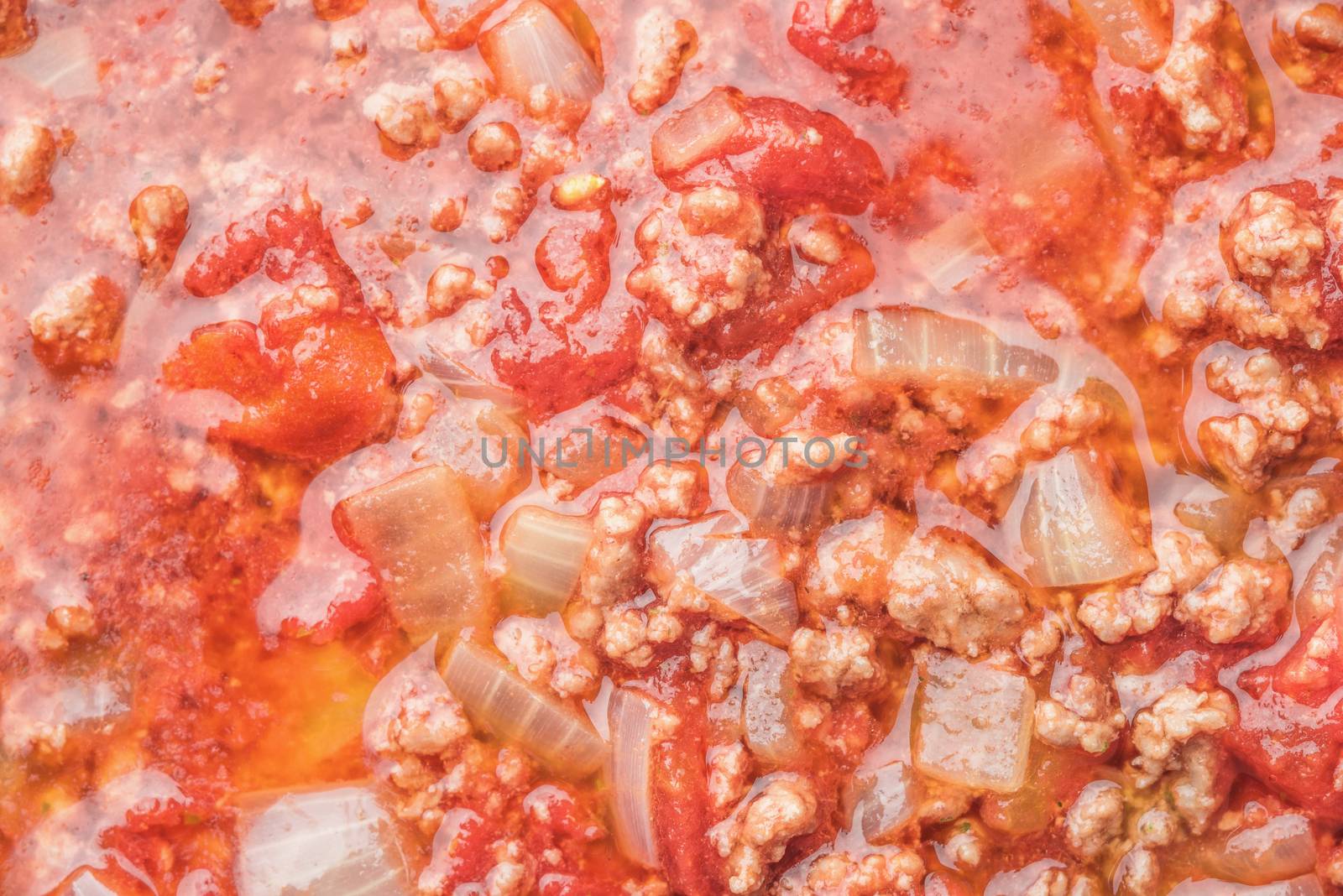 Stew meat with onion and tomatoes background close-up by Deniskarpenkov