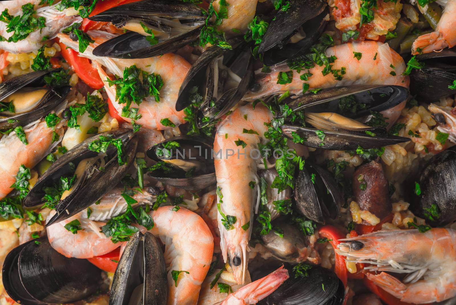 Paella with seafood  and greens background close-up by Deniskarpenkov