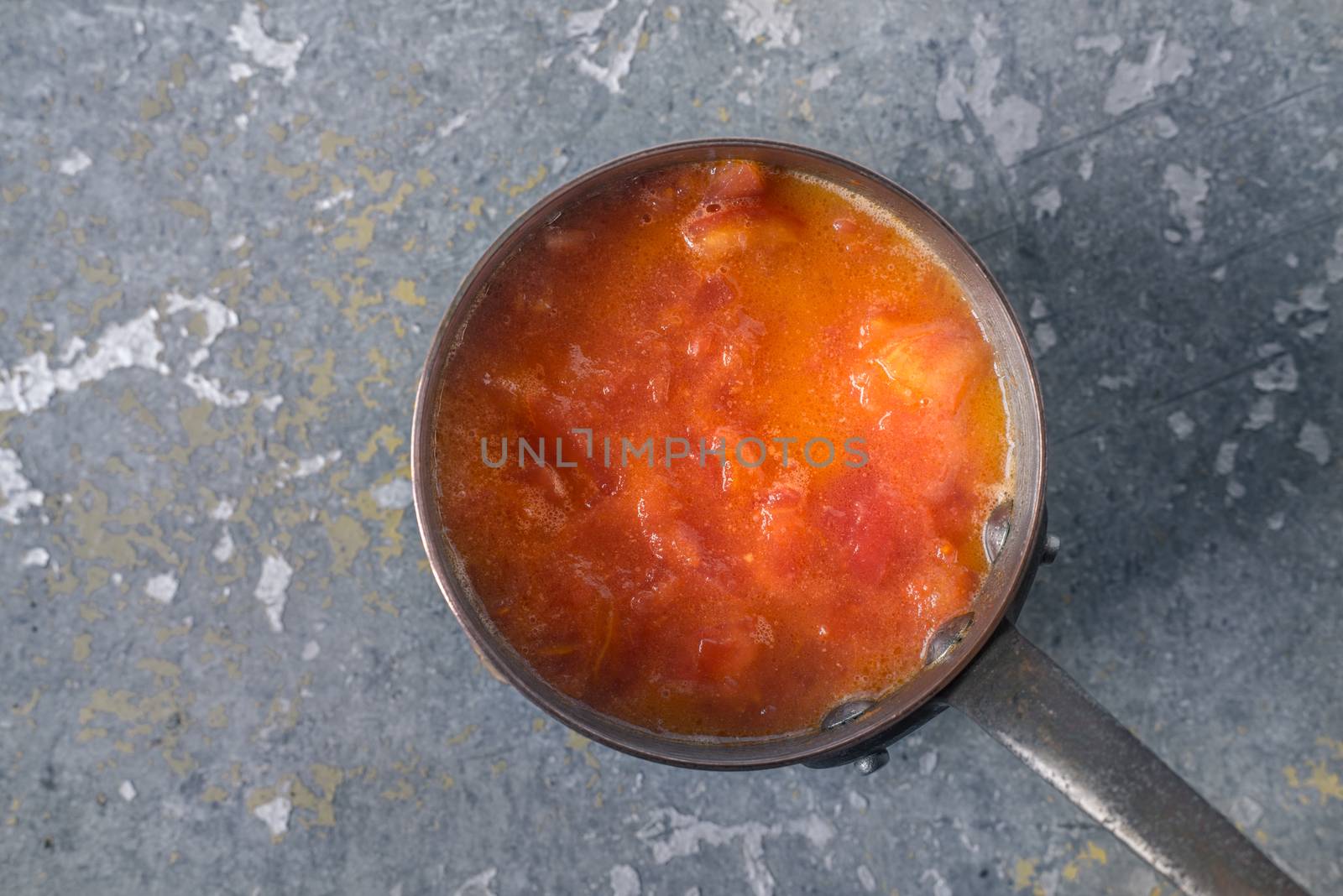 Sliced tomatoes on the metal pot by Deniskarpenkov