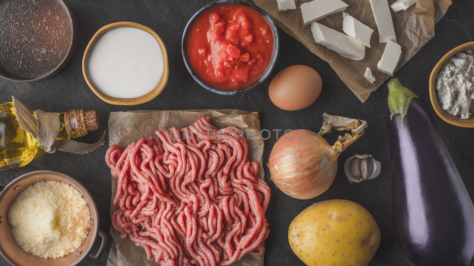 Ingredients for moussaka on the stone table top view by Deniskarpenkov