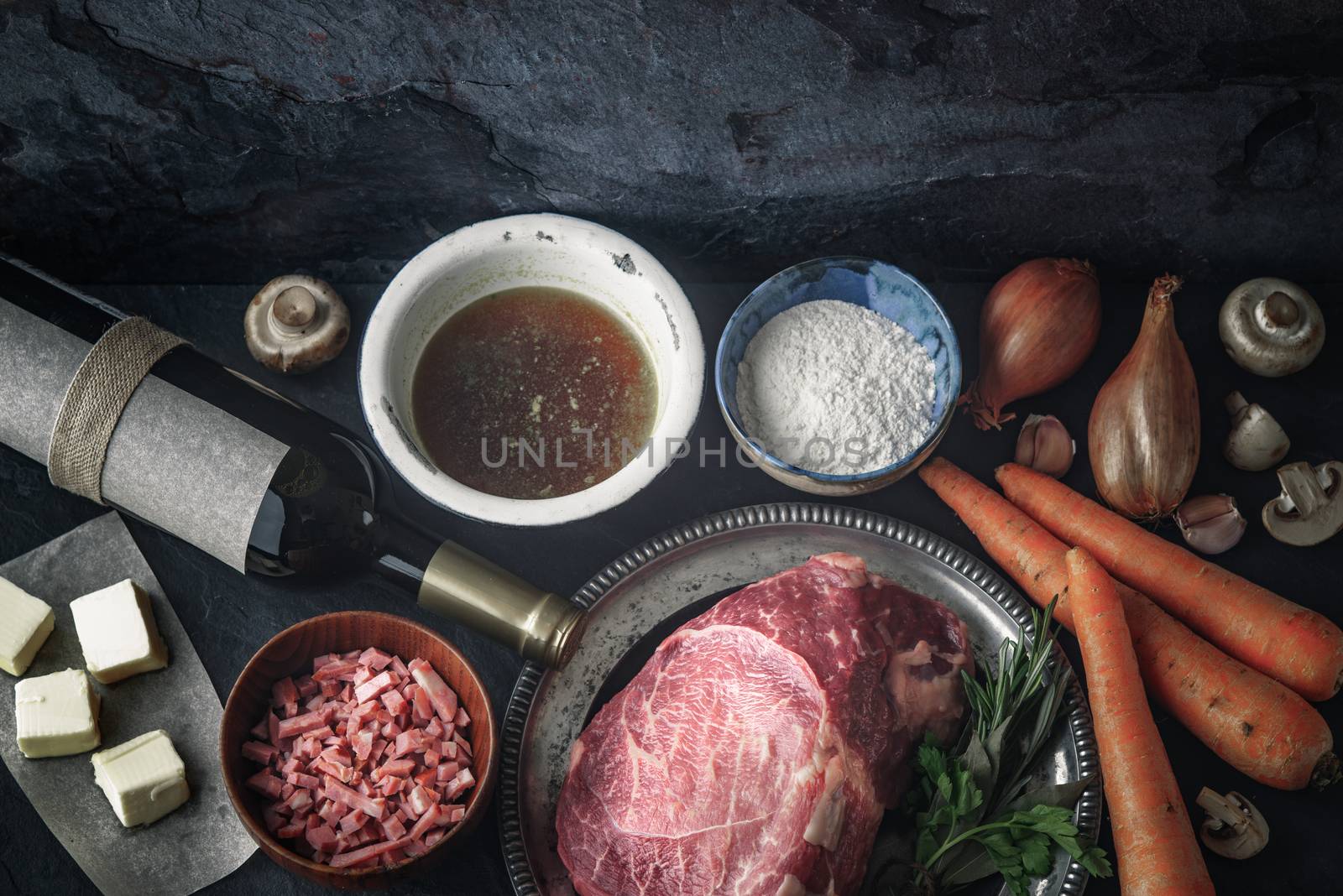 Ingredients for Boeuf Bourguignon on the  dark stone  table top view by Deniskarpenkov
