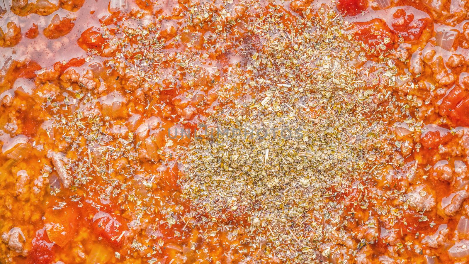 Stew meat with seasoning and tomatoes background close-up