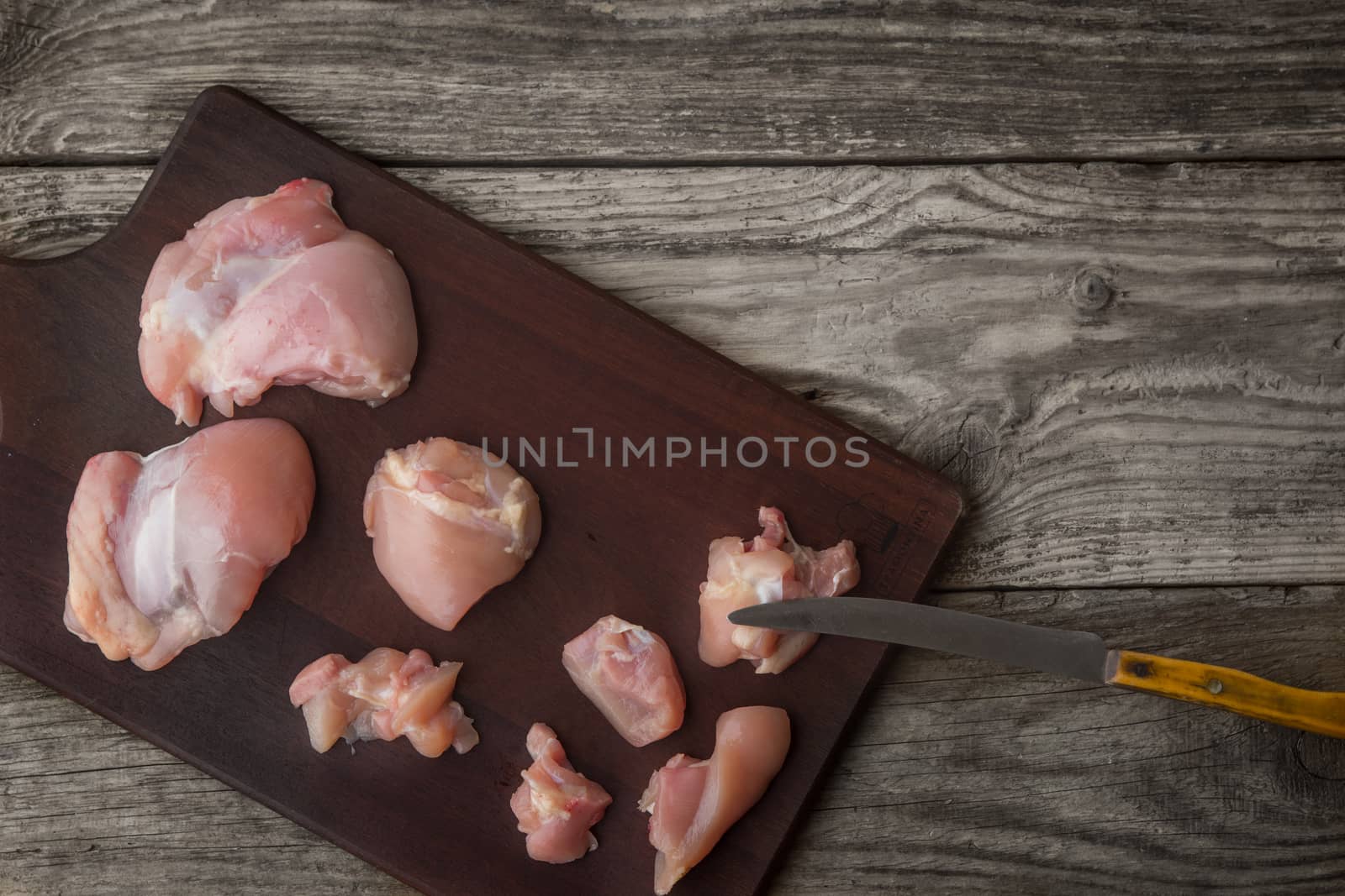 Raw chicken fillet on the wooden board top view