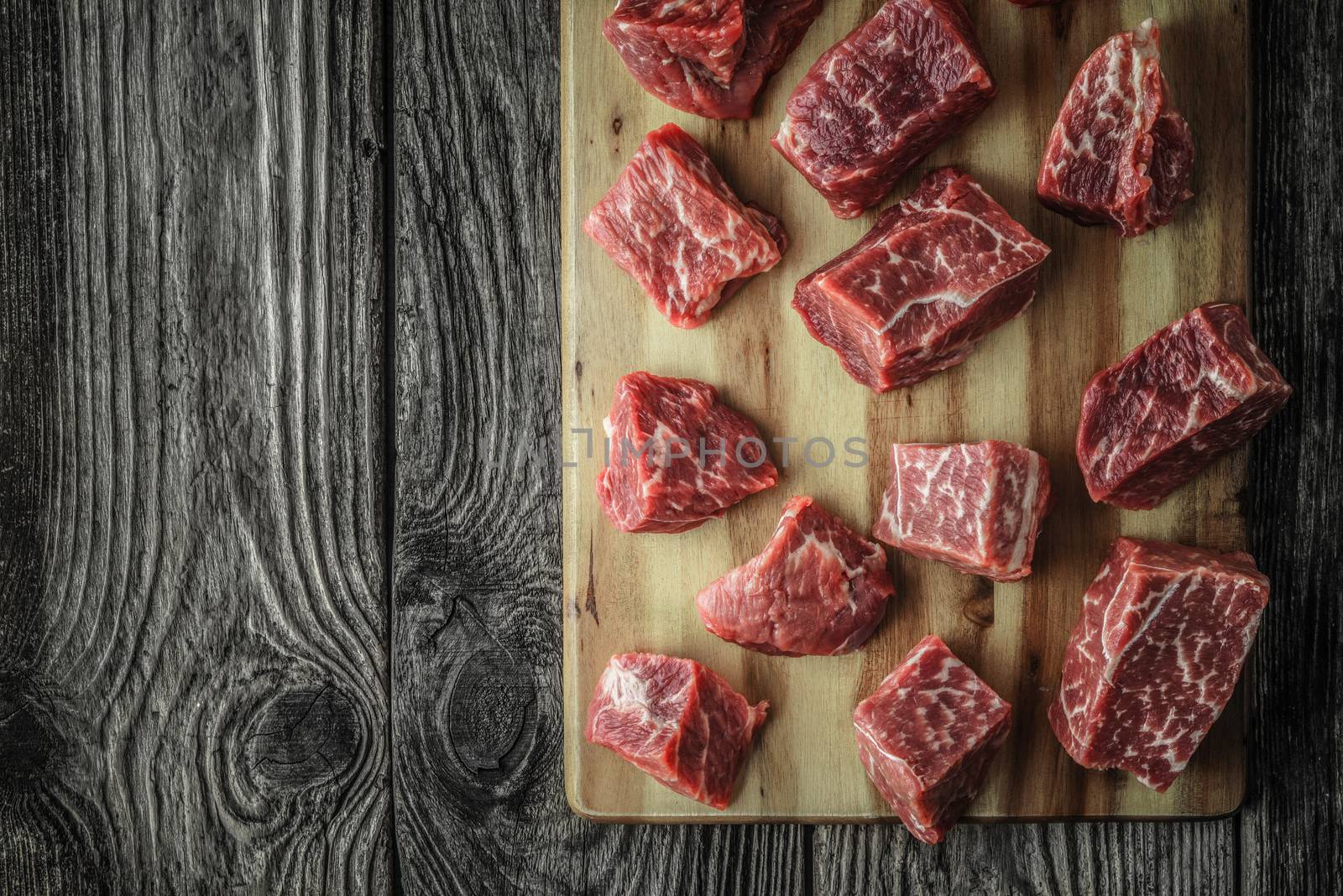 Raw angus beef slices on the old wooden table top view by Deniskarpenkov