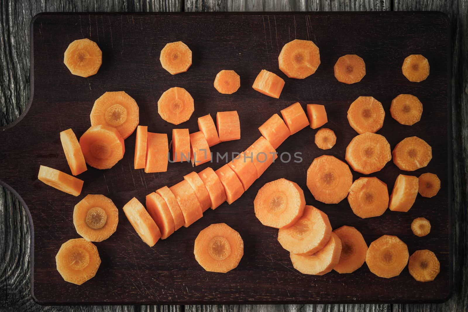 Sliced carrots on the wooden board top view