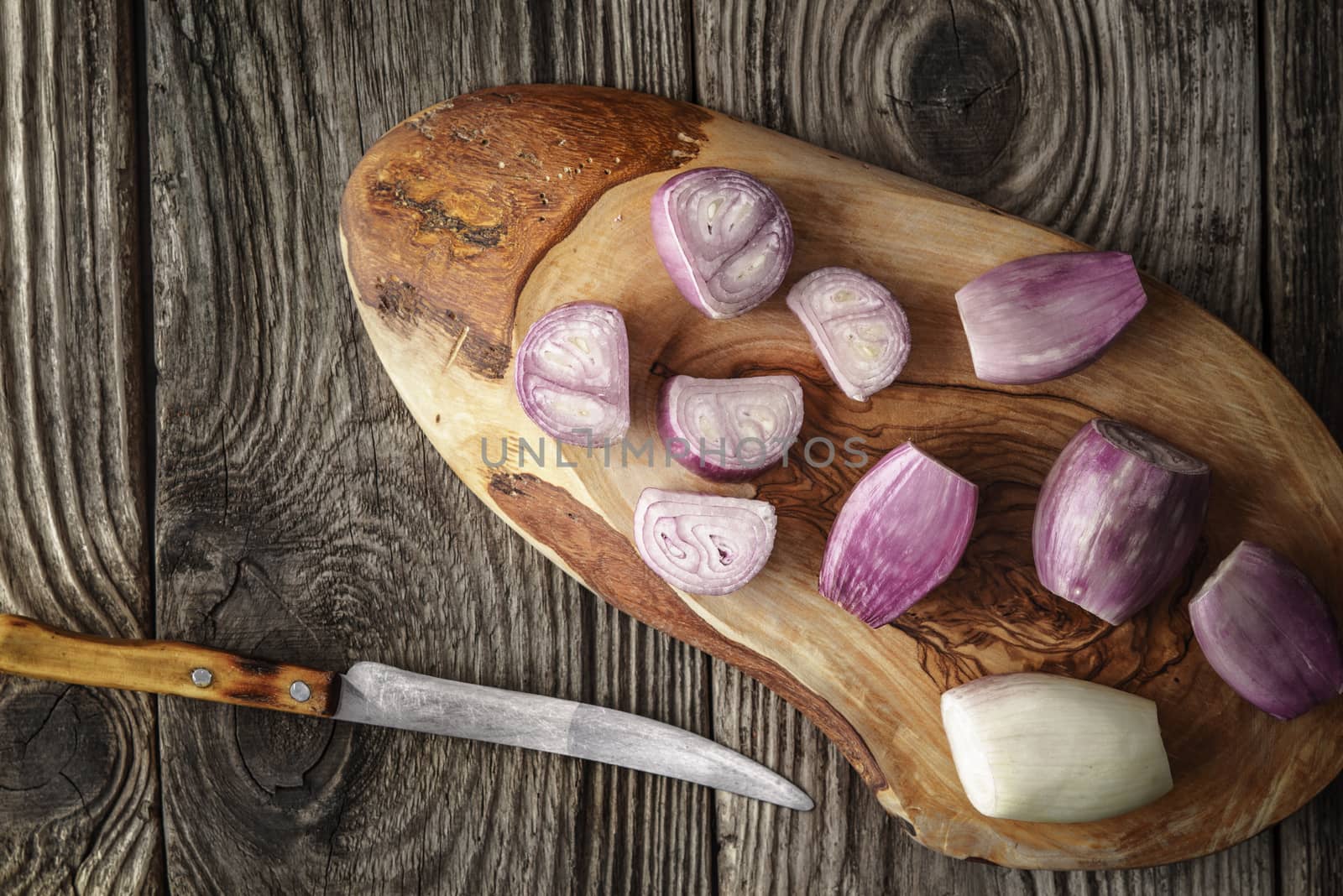 Sliced shallot on the wooden board  top view by Deniskarpenkov