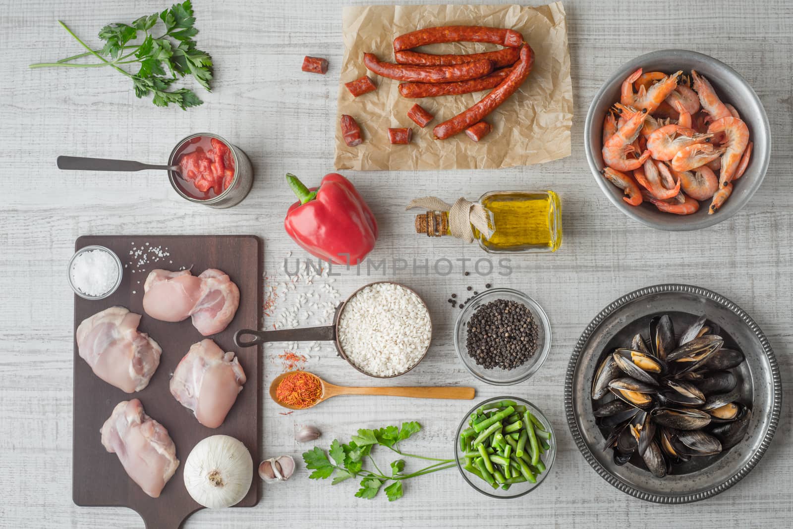 Ingredients for paella on the white  table horizontal by Deniskarpenkov