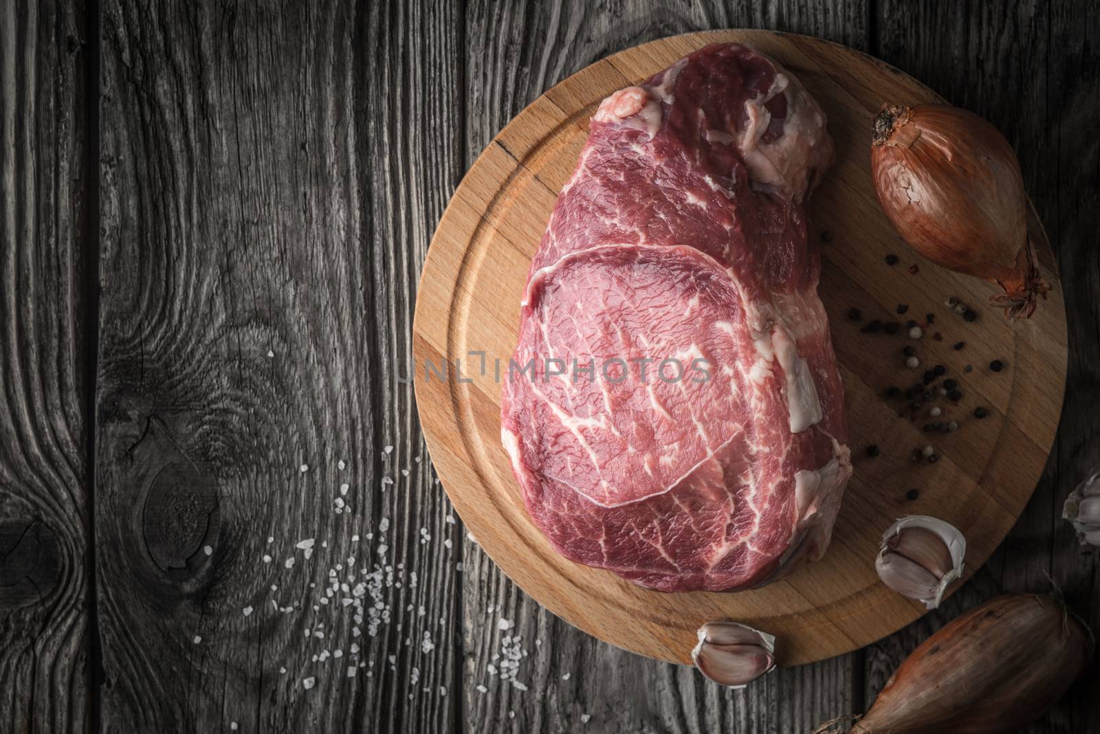 Raw angus beef  with seasoning on the wooden table top view