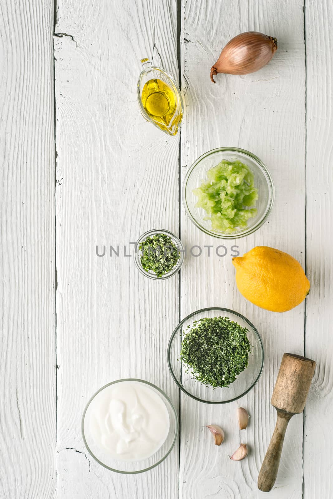 Natural yogurt and different seasoning on the white wooden table by Deniskarpenkov