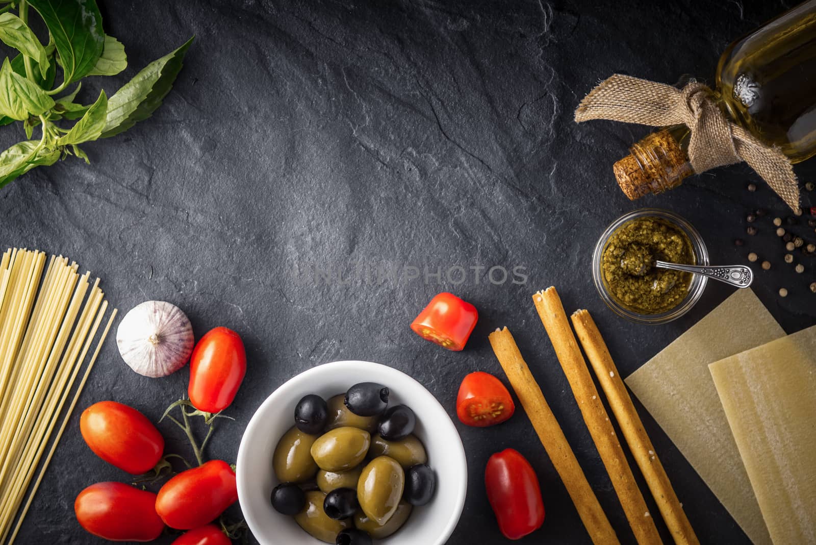 Italian food  mix on the black stone table top view by Deniskarpenkov