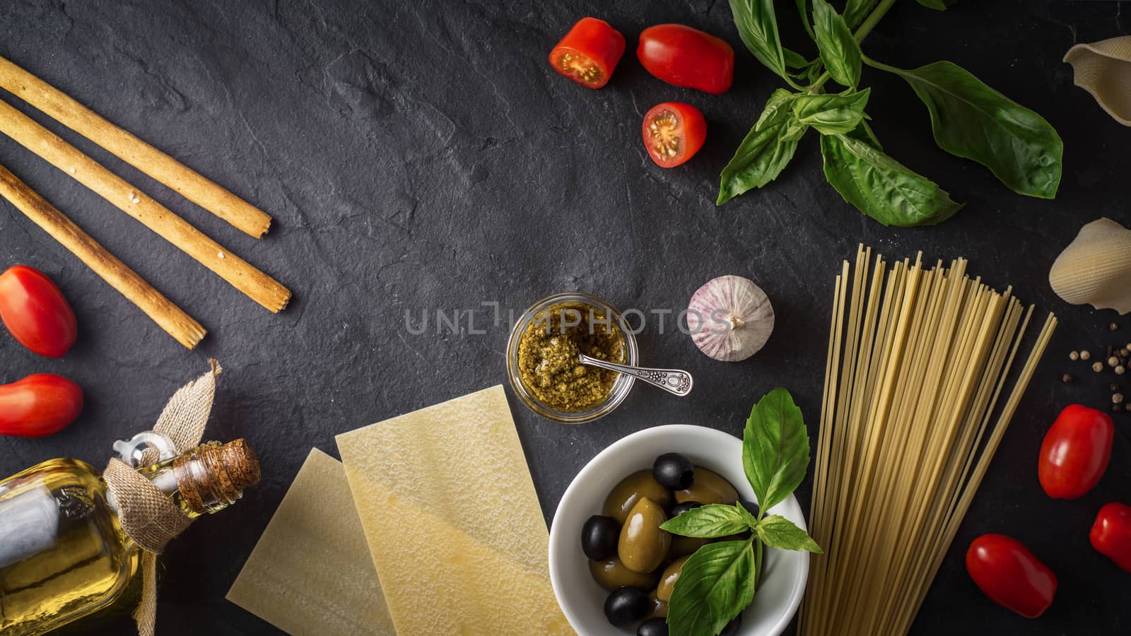 Set of Italian food on the black stone table
