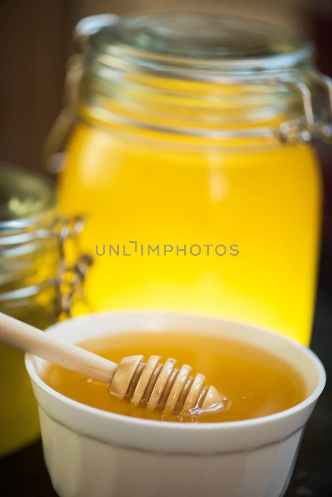 Honey with walnut on wooden background