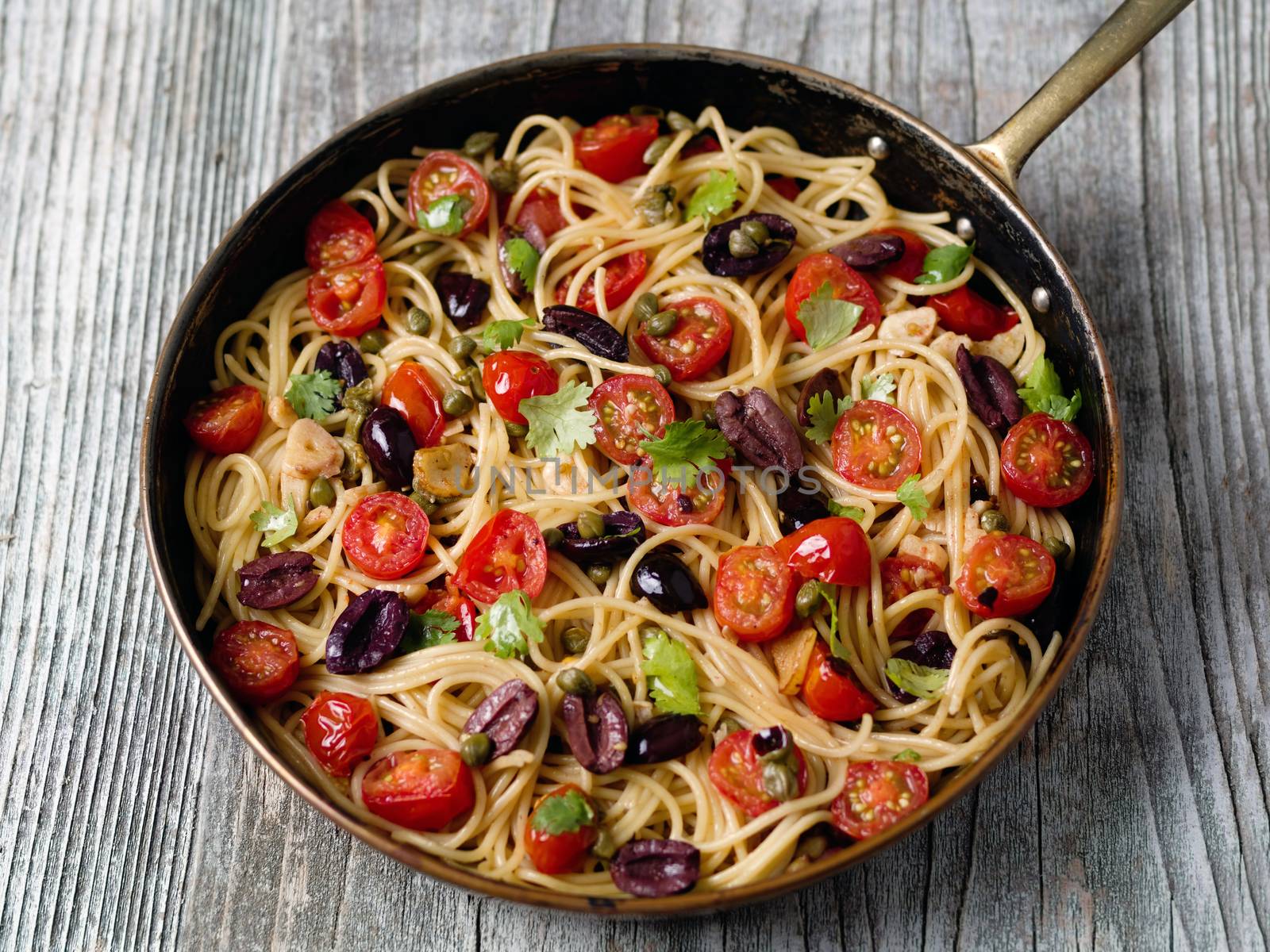 close up of rustic italian spaghetti puttanesca pasta