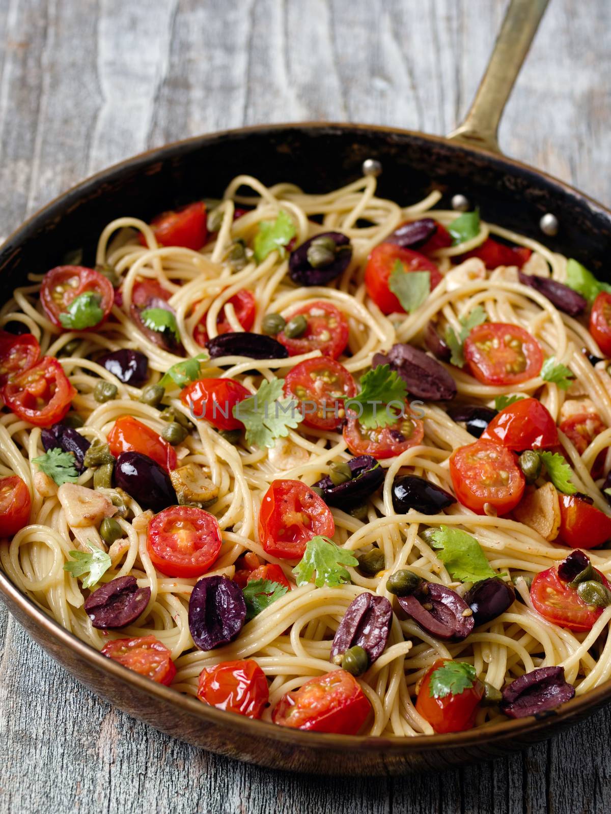 close up of rustic italian spaghetti puttanesca pasta