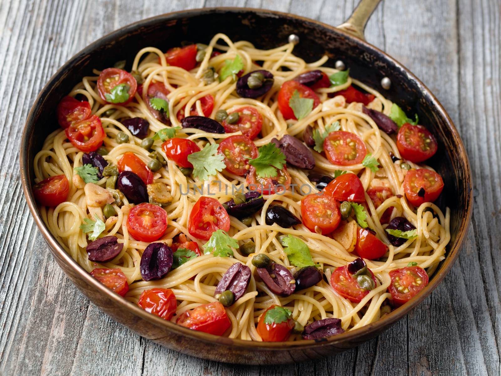 close up of rustic italian spaghetti puttanesca pasta