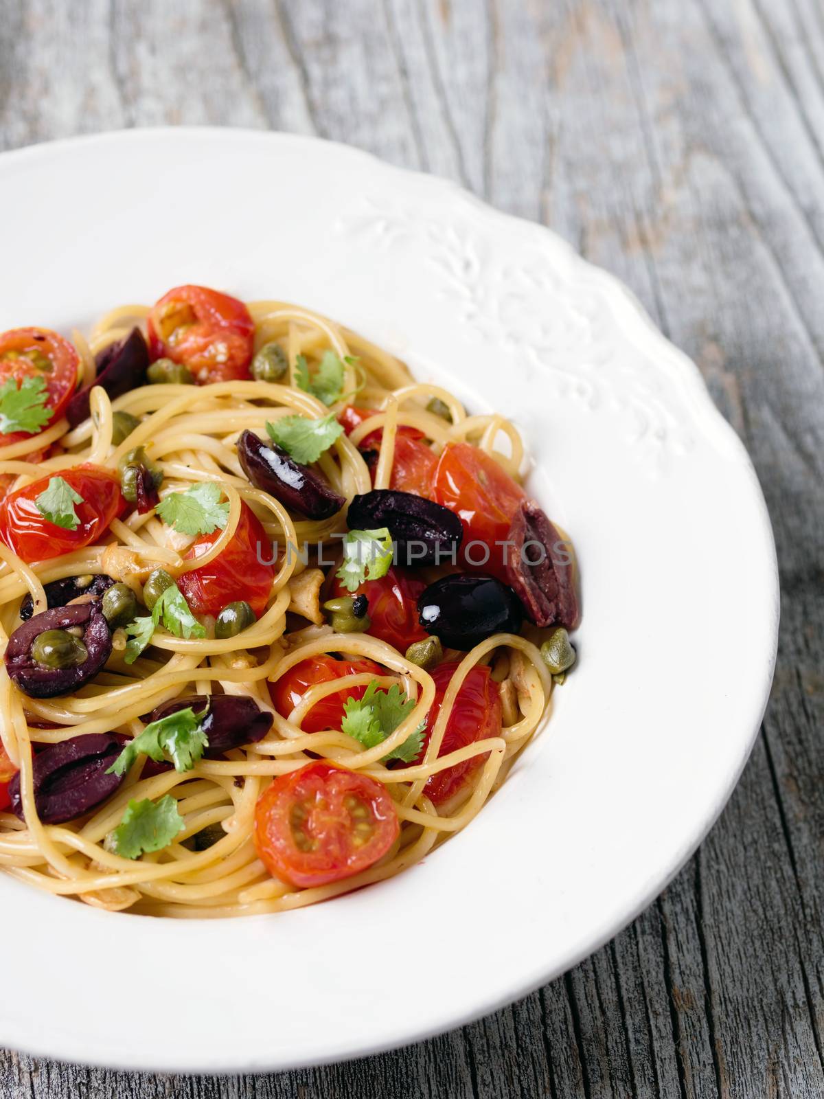 close up of rustic italian spaghetti puttanesca pasta