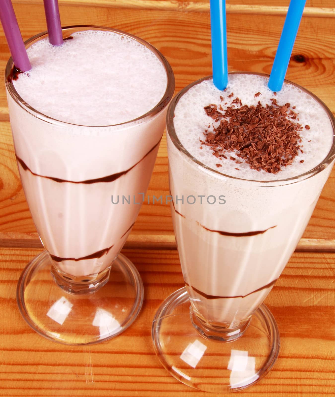 two cocktails with straw on wooden background