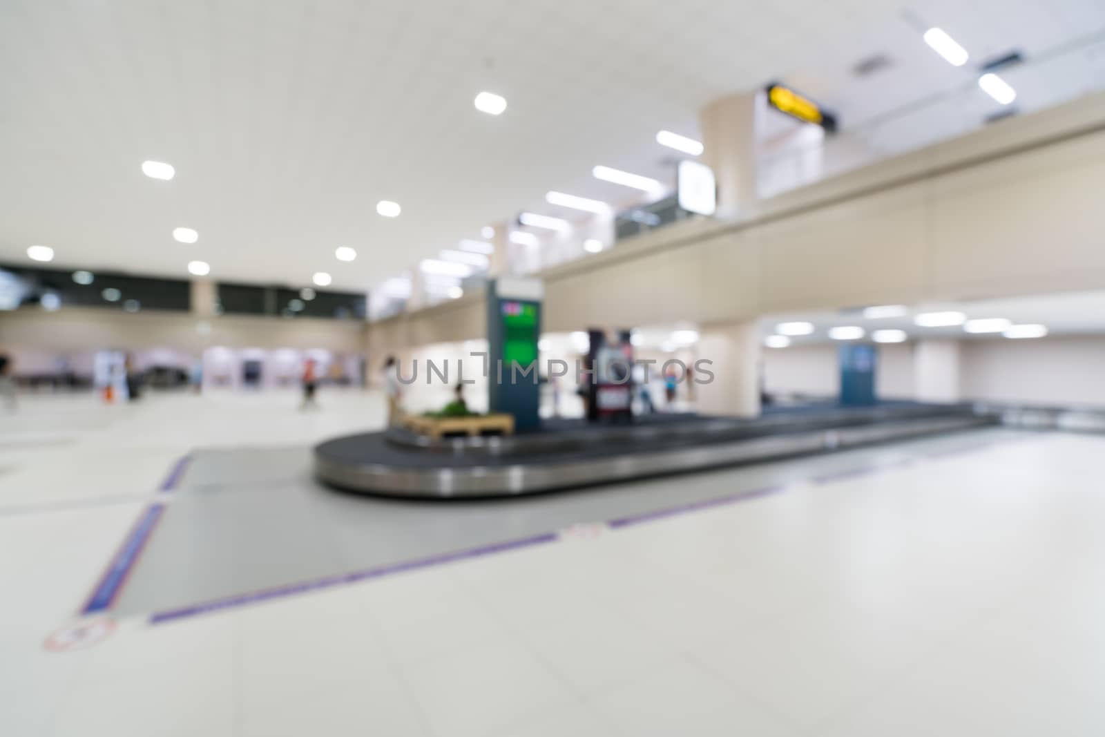 Blurred, bokeh background of baggage claim belt area in arrival zone of an airport by beer5020