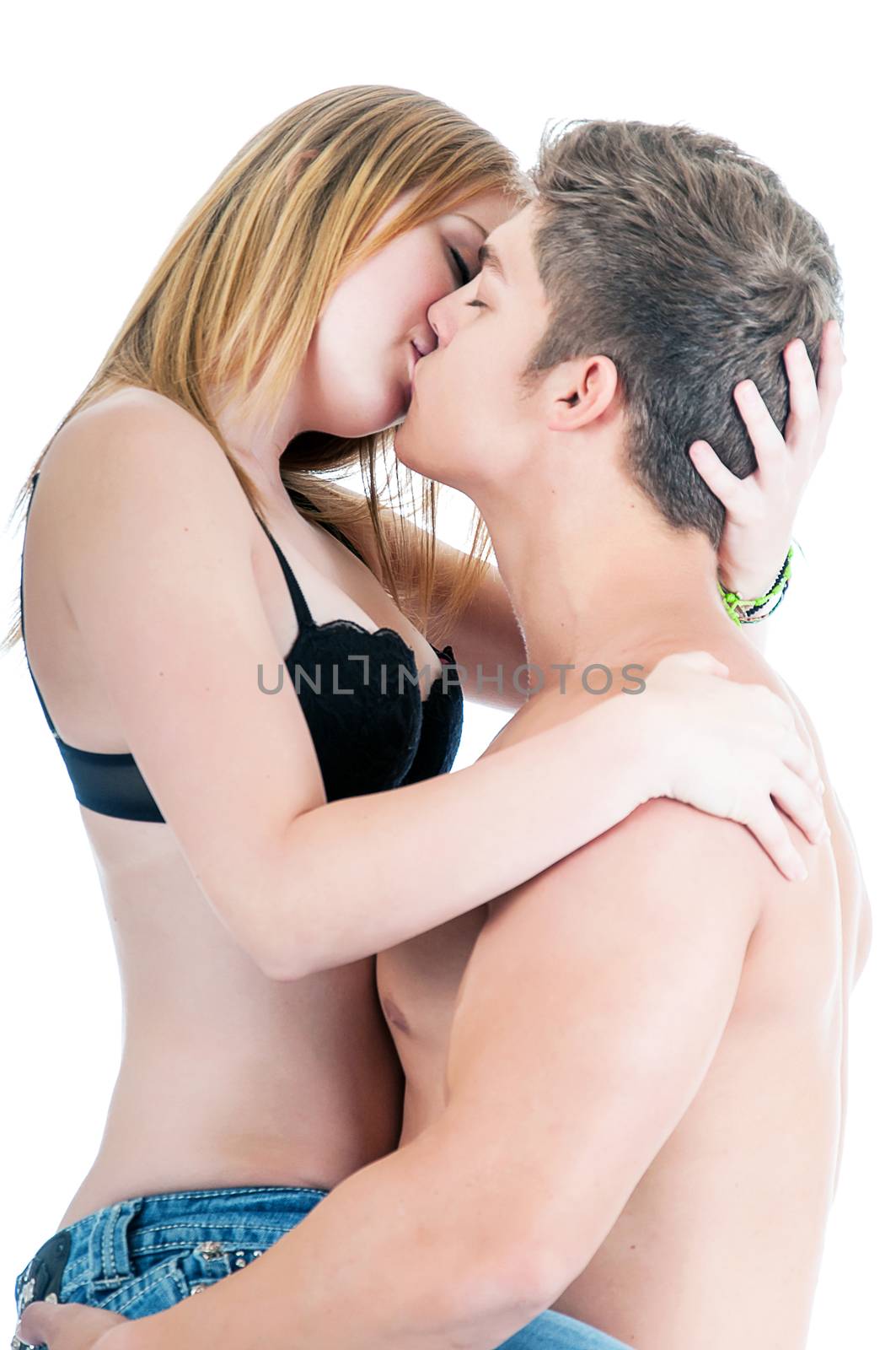 Young couple kissing while in a romantic embrace. Isolated on a white background