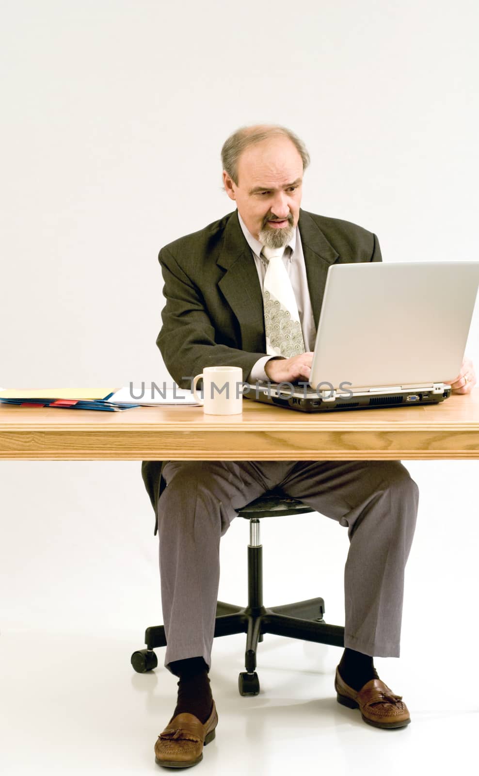 Businessman in suit typing on a laptop computer