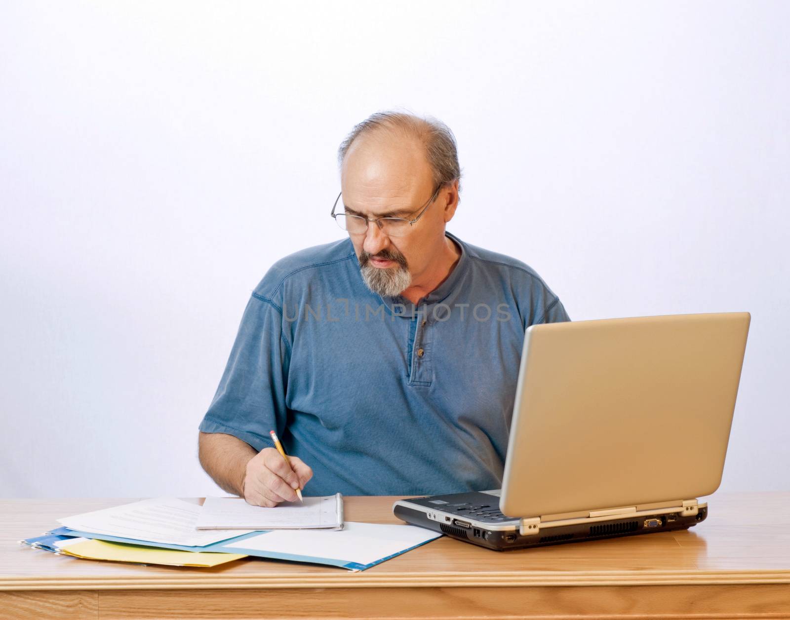 Businessman working with a laptop computer at his desk.
