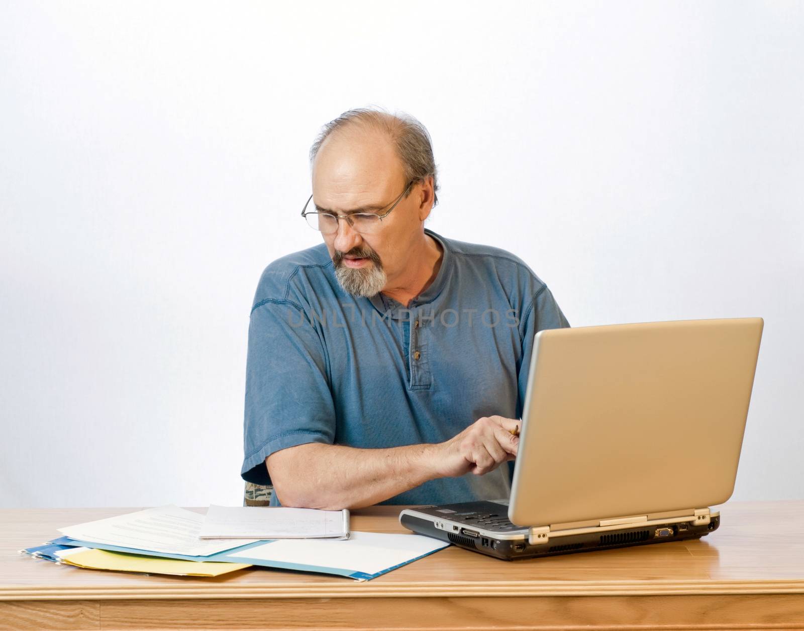 A businessman transcribes his notes onto the computer.