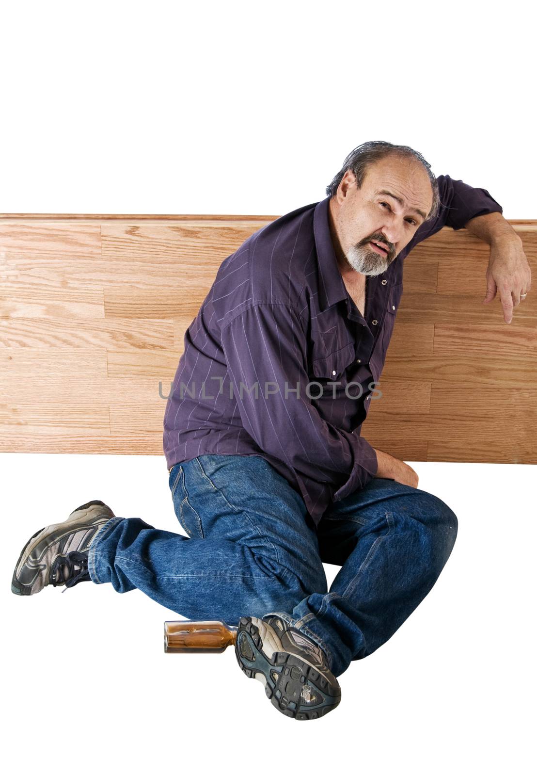 A homeless man awakes after a night of drinking. Isolated with clipping path