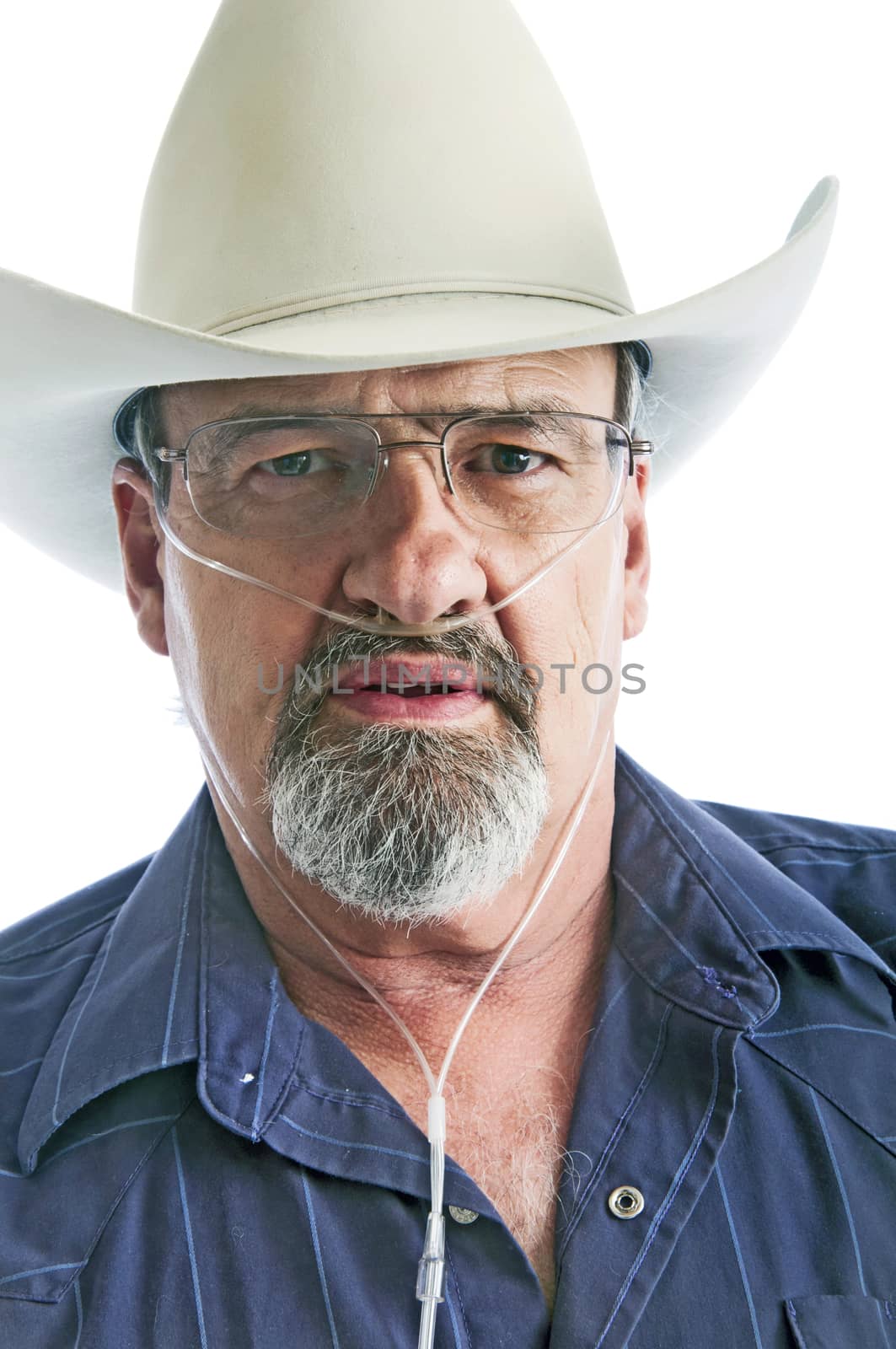 Mature cowboy with a breathing disability, wearing an Oxygen cannula and eyeglasses.