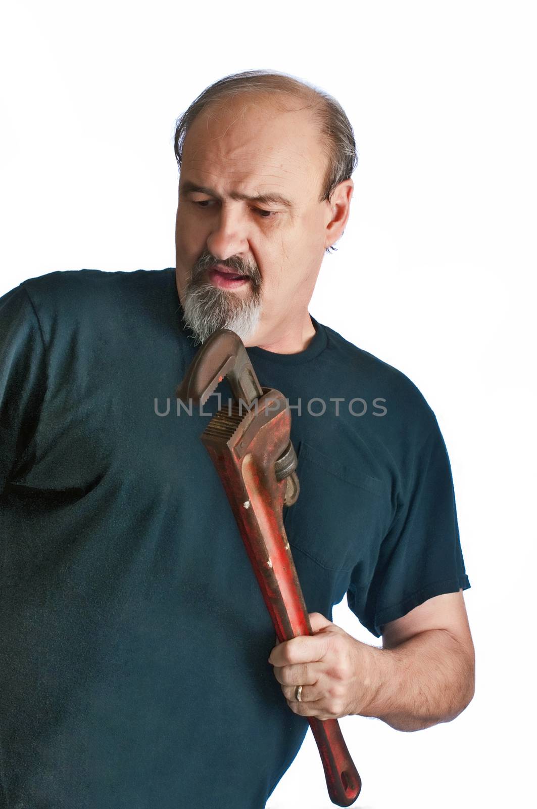 Adult male fixing a problem with a pipe wrench