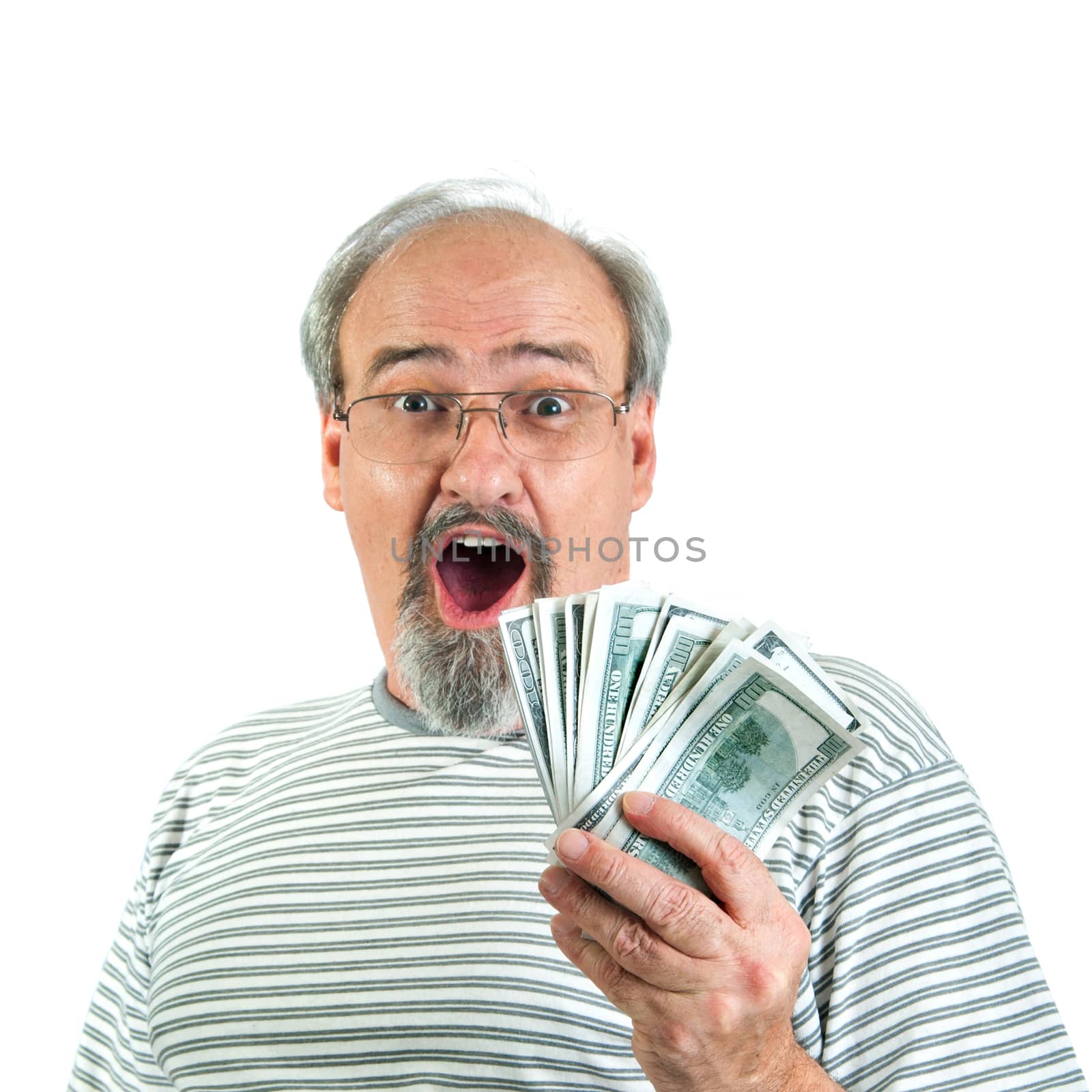 Adult male showing a look of amazement and surprise while holding a handful of one hundred dollar bills of American money.