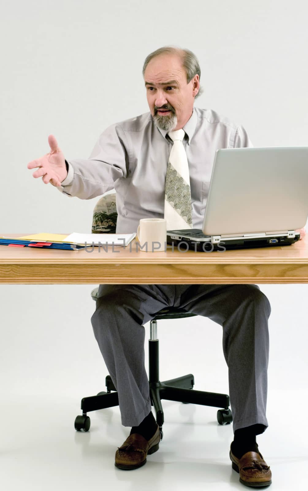 Businessman using his hands to gesture while he explains the benefits of his services.