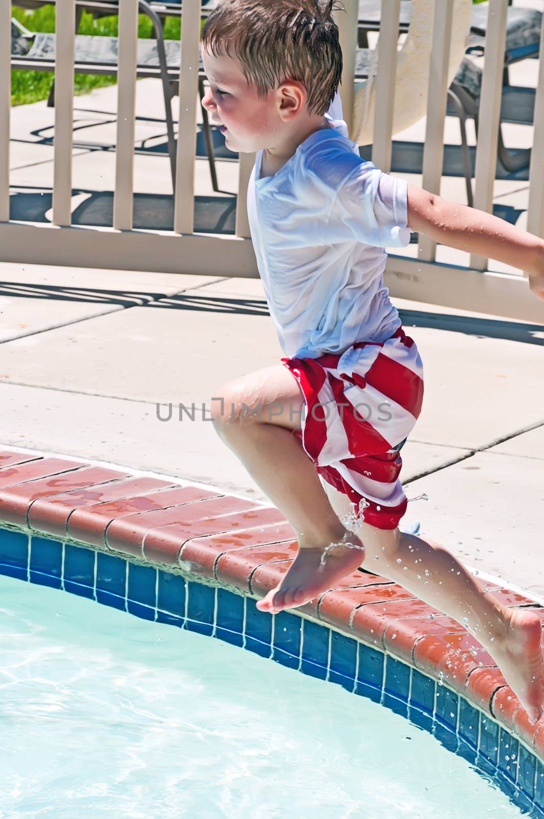 Little boy playing in a swimming pool