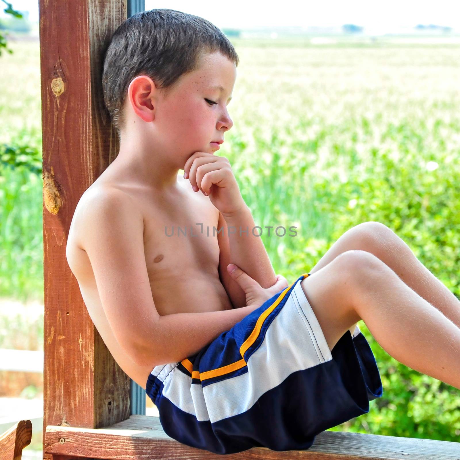 Small Boy Taking a Break on a Hot Summer Day by rcarner