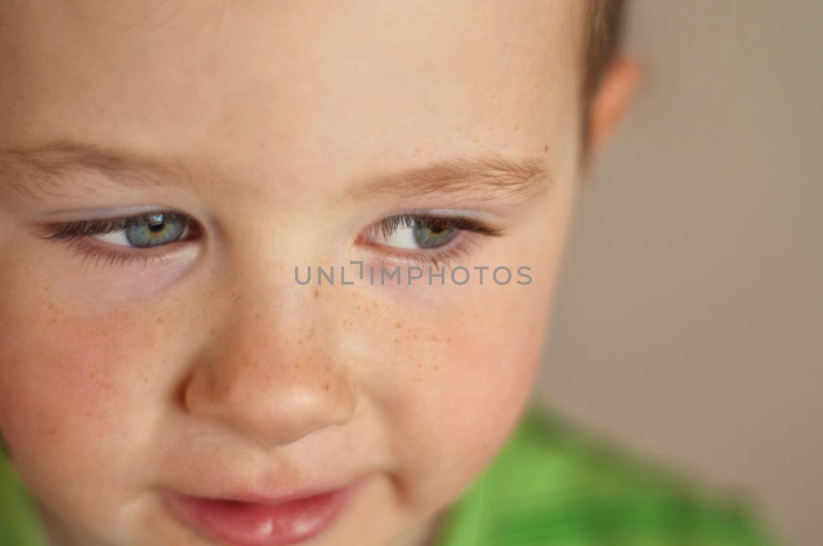 Cute little boy with camera focus on his beautiful clear blue eyes