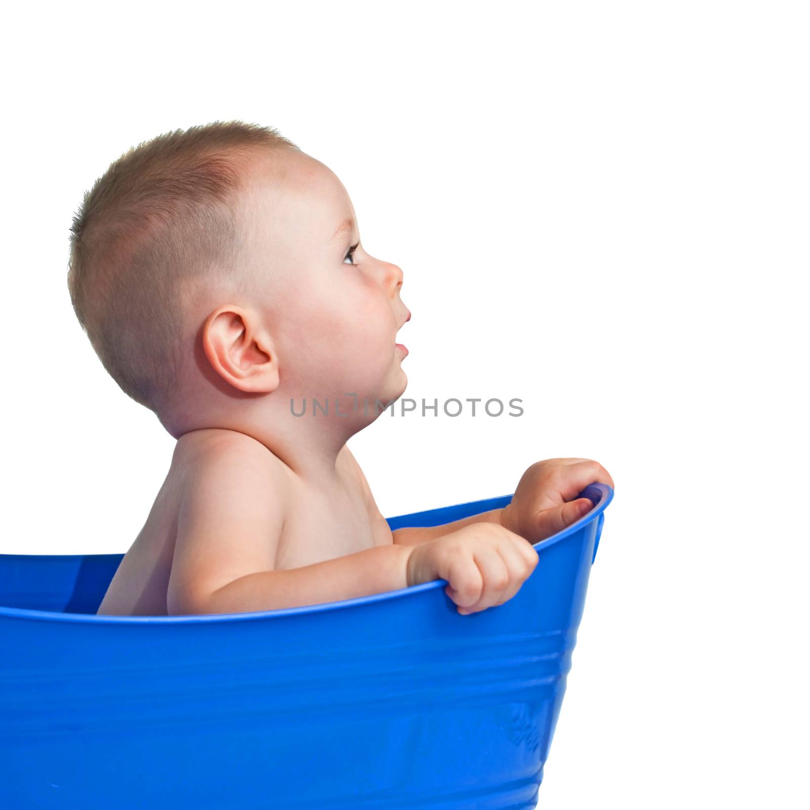 Cute baby in plastic tub looking to the front. Isolated on a white background.