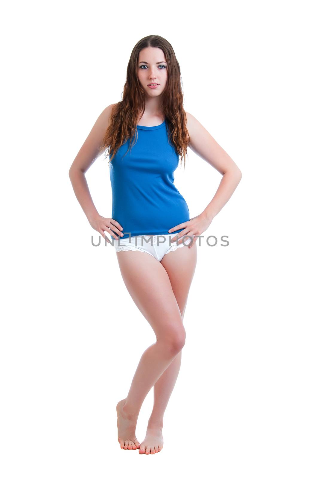 Pretty young brunette woman posed in white panties and a blue camisole isolated against a white background