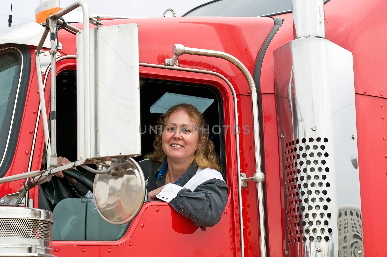 Woman Driving An Eighteen Wheeler by rcarner