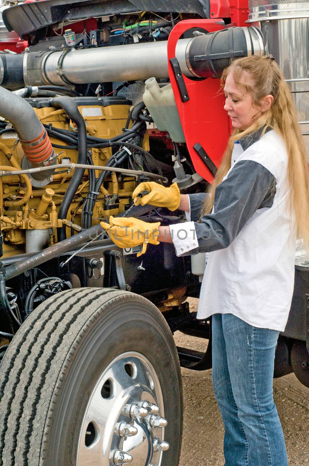 A driver doing her pre-trip inspection prior to leaving.