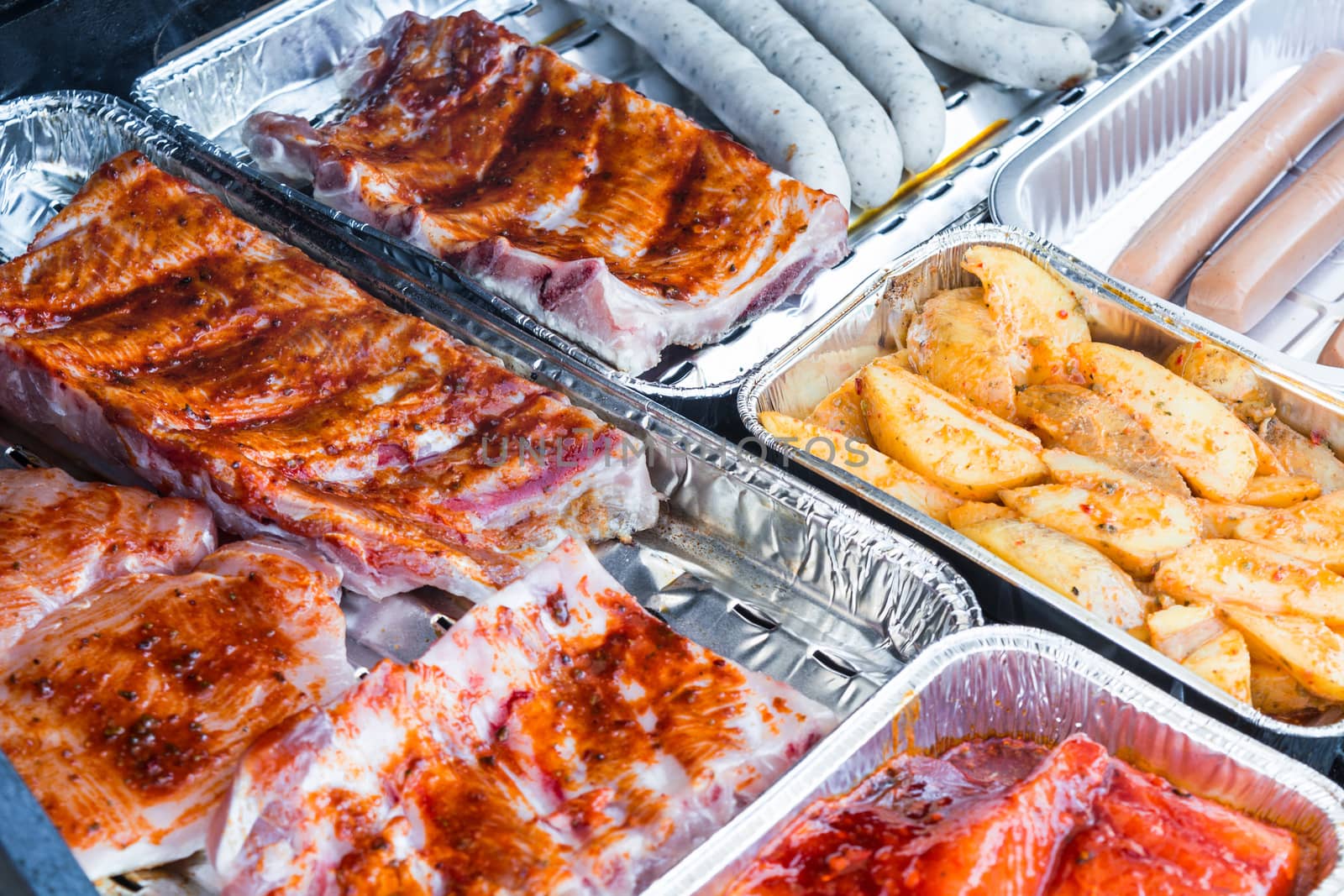 Different tasty grilled meat and sausages on a grill