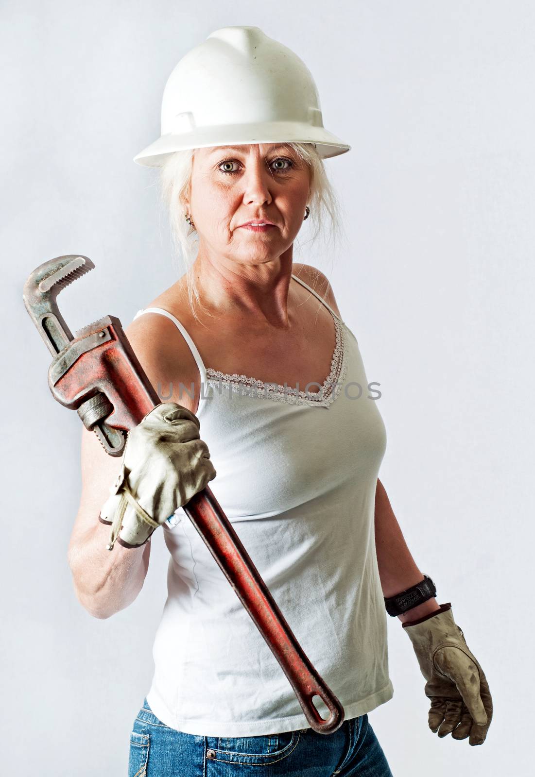 Woman Plumber Holding A Pipe Wrench by rcarner