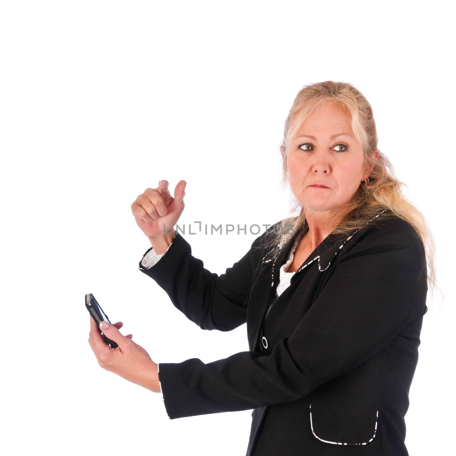 Adult woman angry about a message on her cellphone looking back over her shoulder. Isolated on a white background.