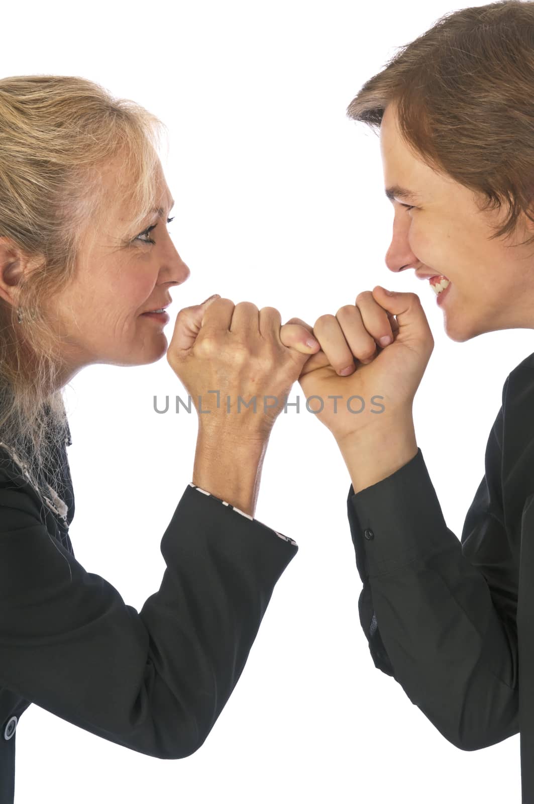 Active mother making a pinkie promise with her teenage son.