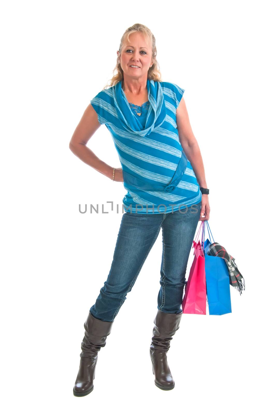 Pretty blonde woman with a couple of bags of gifts she recently bought for freinds. Isolated on a white background.