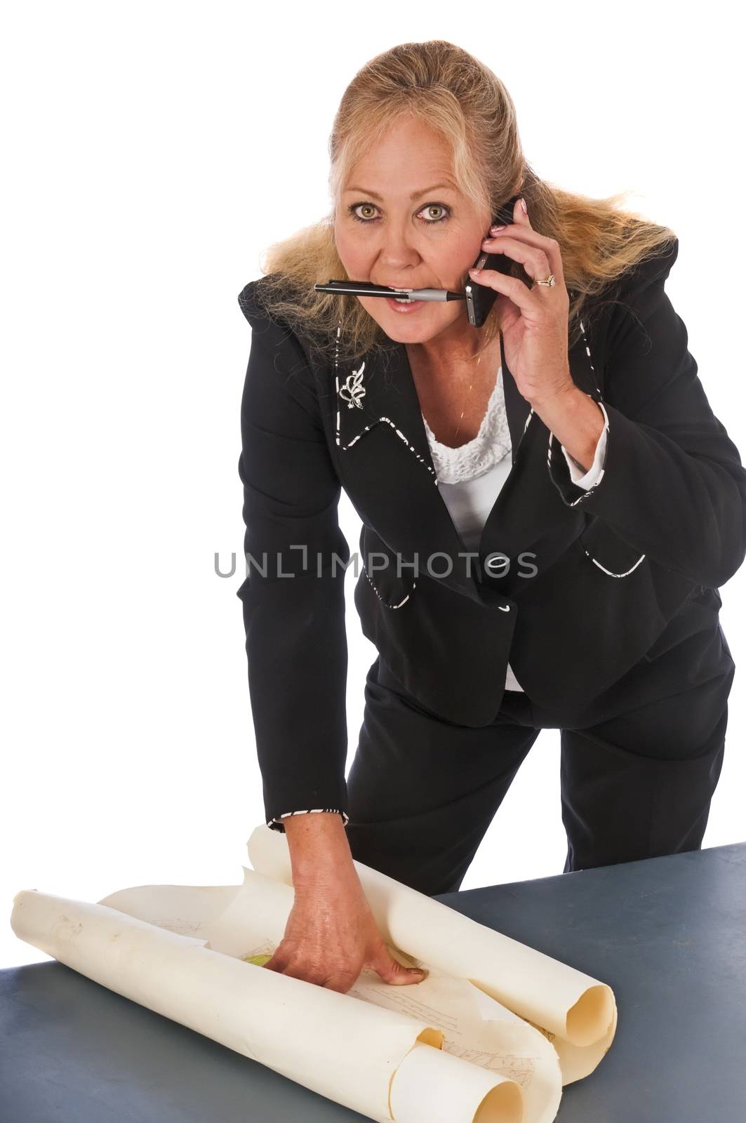 Pretty mature woman running a project at a construction or surveying site. Isolated on a white background